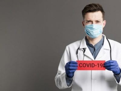 Doctor Holding Covid 19 Card