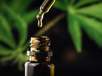 Cbd Hemp Oil In A Droplet With Marijuana Plant
